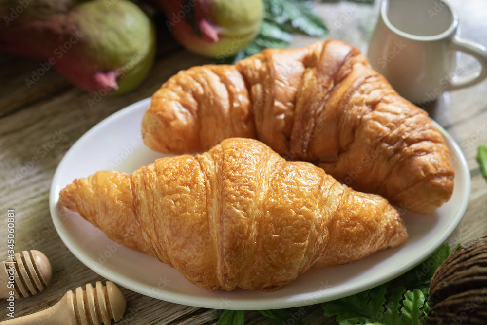 Tasty buttery croissants on  wooden table