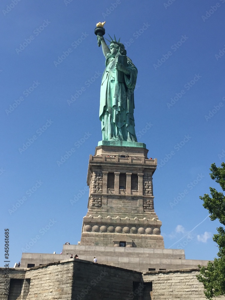 The Liberty statue of New York City at the sun light