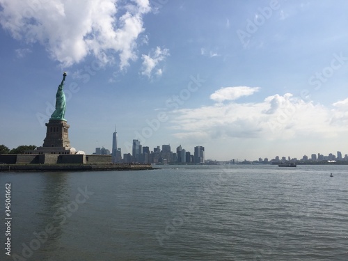 New York City Manhattan skyline from the sea with the liberty statue in a sunny day © Javier
