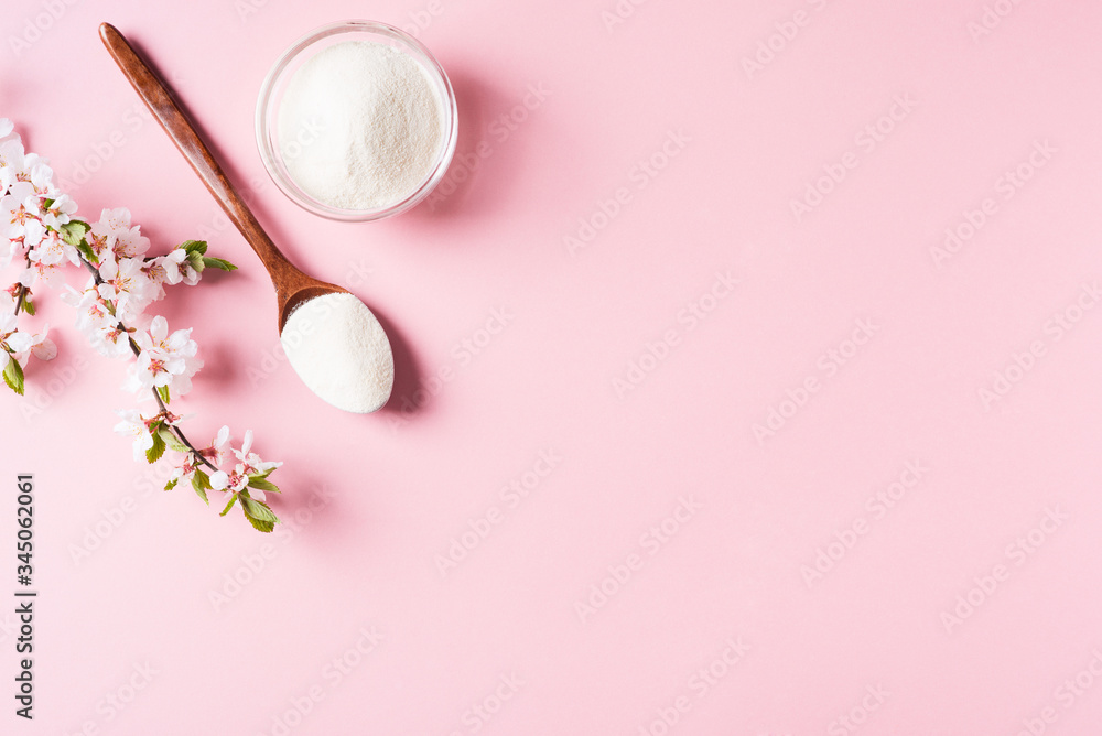 Collagen powder in wooden spoon, supplement, healthy and anti age concept flat lay on pink background Collagen powder in wooden spoon, supplement, healthy and anti age concept flat lay on pink background