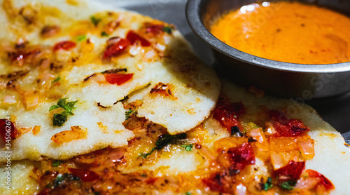 Delicious South Indian Dish Uttapam with spicy coconut chutney photo