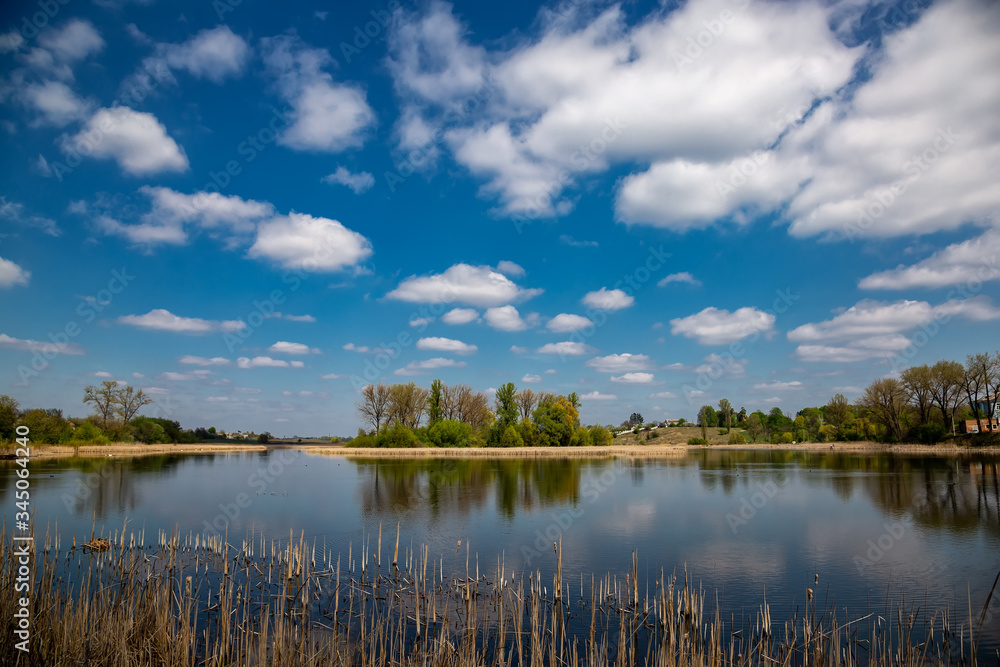 Beautiful river in the village on a sunny day with clouds. rest in the village