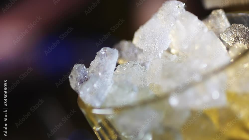 Glass Filled with Crush Ice and Alcohol Being Poured on It Glass Filled with Crush Ice and Alcohol Being Poured on It