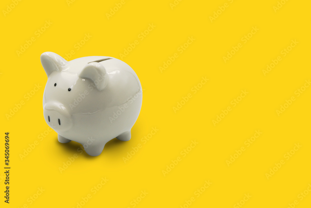 white piggy bank isolated on yellow background ,with copy space white piggy bank isolated on yellow background ,with copy space