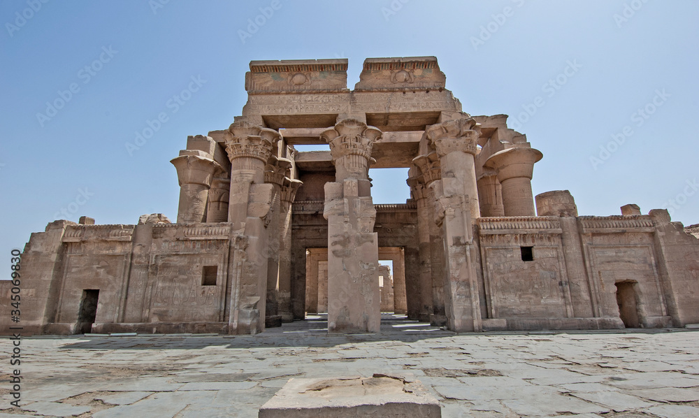 Columns and entrance to an ancient egyptian temple wall