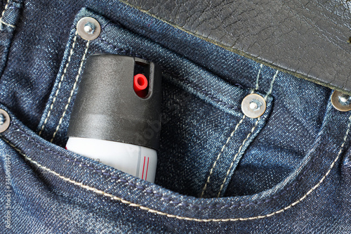 Tear gas or pepper spray in jeans pocket. Self defense tool. photo