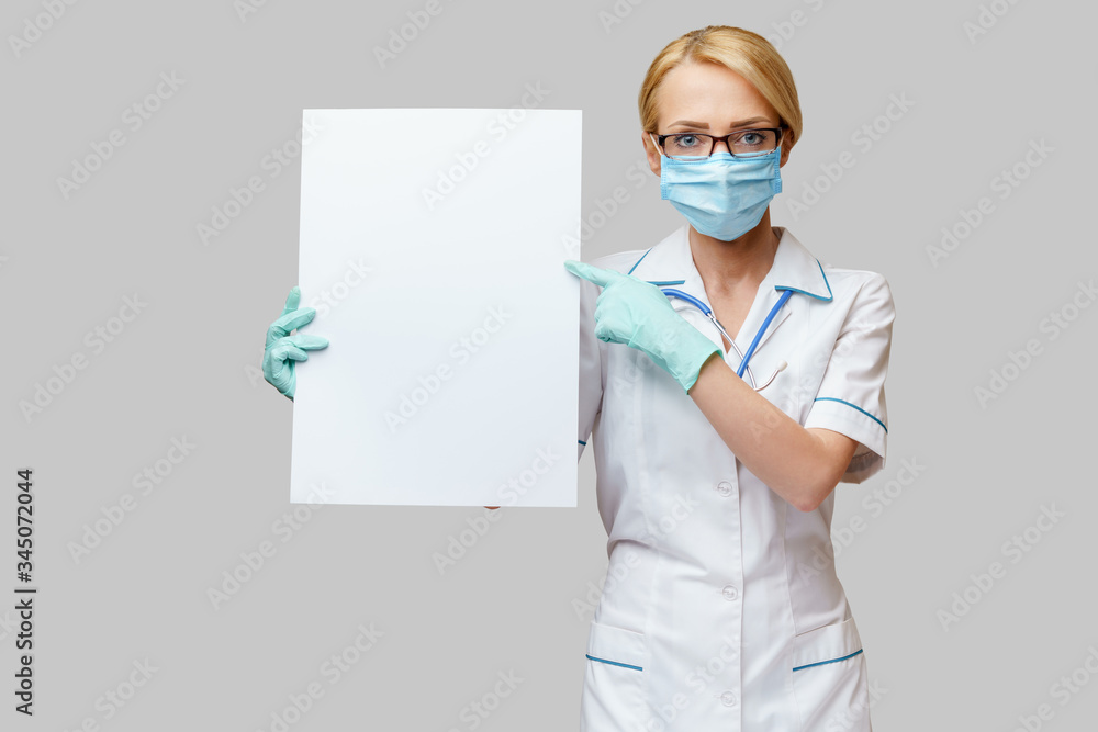 Doctor or woman nurse showing blank empty sign with copy space Doctor or woman nurse showing blank empty sign with copy space