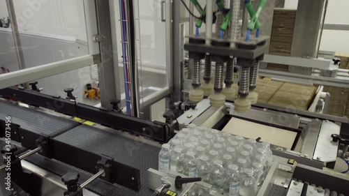 glass bottles on a medical solution conveyor at packing station medical industry
