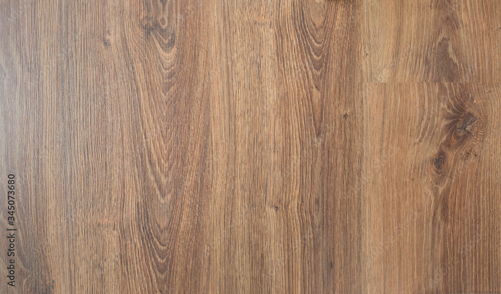 Naklejka premium Wooden brown textured floor or desk background and texture of Walnut wood decorative furniture surface