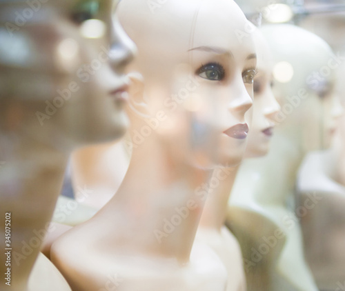 Naked female mannequins in the shop window.