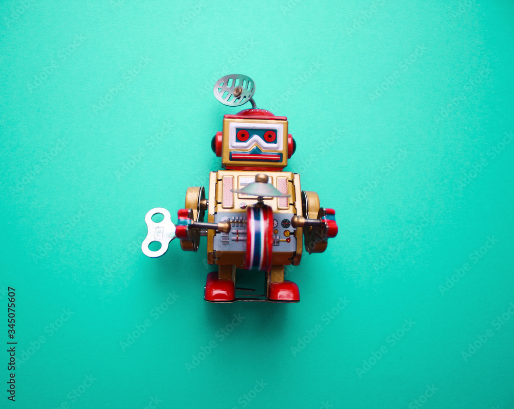 Vintage clockwork metal toy robot on the pastel blue background. Retro toys minimal concept. Flat lay. Top view.	
