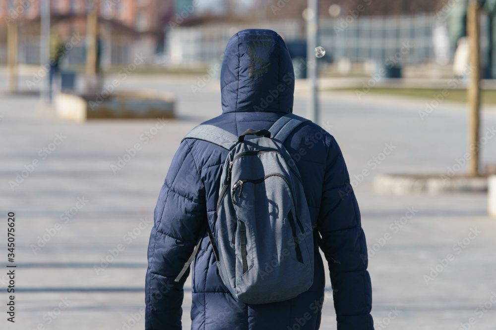 People on the Moscow street in the spring time. Young woman jogging. Back / rear view. Coronavirus Pandemic lifestyle of the big city People on the Moscow street in the spring time. Young woman jogging. Back / rear view. Coronavirus Pandemic lifestyle of the big city