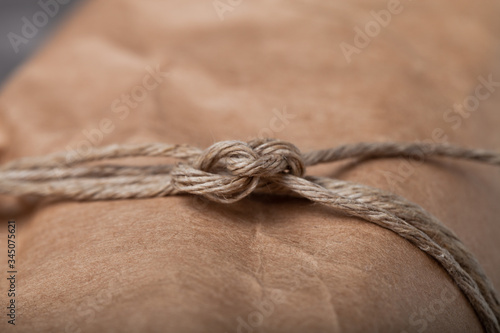 Composition with a rope and paper on a textured plastered surface