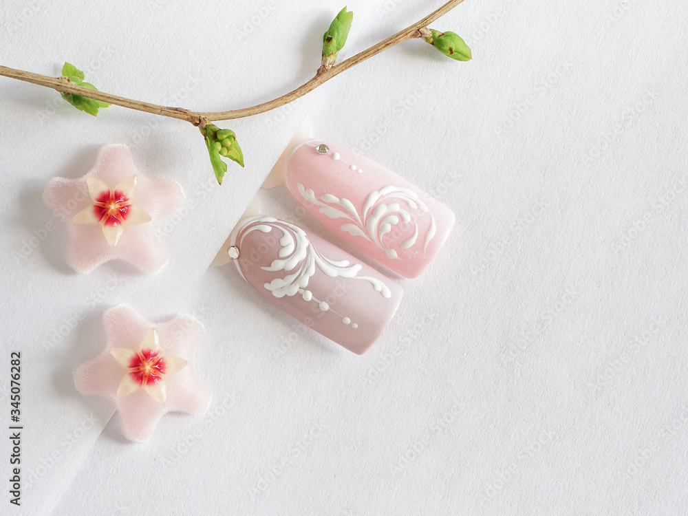 Spring manicure. Tips with spring flower design on a white background Spring manicure. Tips with spring flower design on a white background