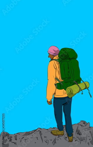 Vector illustrated young man standing on a rocky mountain with blue sky on the background.