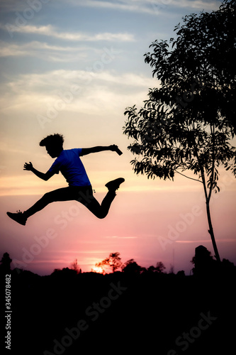 Freedom-young man is jumping at lake with sunset sky © songphon