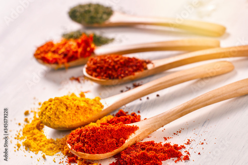 Closeup of bright spices pepper, paprika, saffron, mint