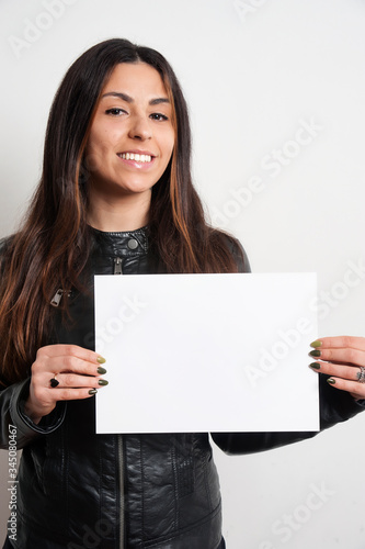 beautiful smiling brunette girl with placard