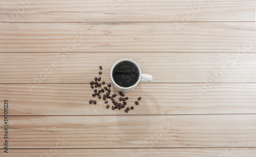 Black coffee resting on a wooden table, top view, Morning life at work concept.