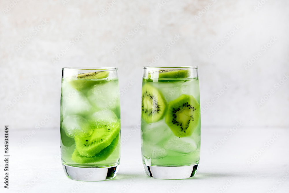Glass of Refreshing Tropical Kiwi Lemonade With Ice on Light Gray Background Tasty Summer Beverage Healthy Detox Diet Drink Horizontal Glass of Refreshing Tropical Kiwi Lemonade With Ice on Light Gray Background Tasty Summer Beverage Healthy Detox Diet Drink Horizontal