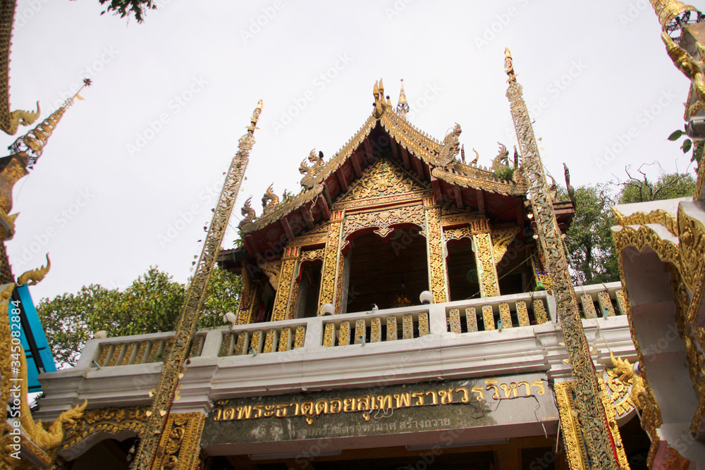 Naklejka premium Elevated and highly ornamented golden temple at Doi Suthep