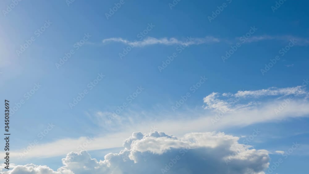 White clouds on blue sky background. 4k time lapse footage.