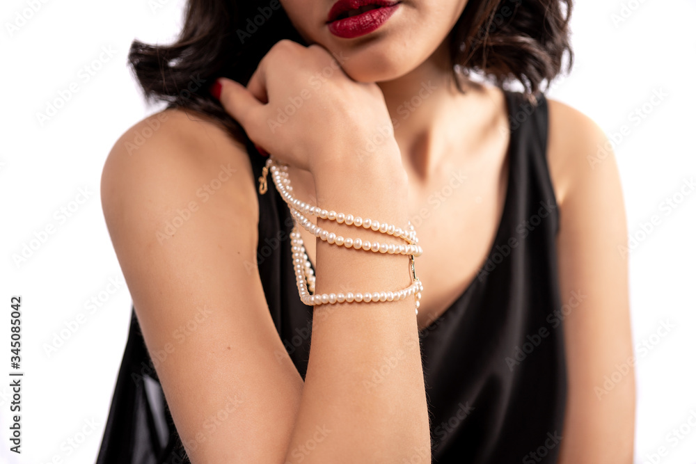 woman wearing pearl diamond wristband on white background woman wearing pearl diamond wristband on white background