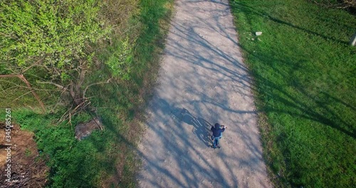 a child riding a bike in the countryside,video shot on a drone