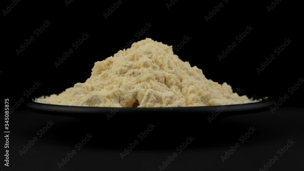 Cornflour of spin around themselves on a black background and ground Cornflour of spin around themselves on a black background and ground
