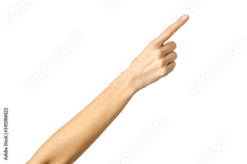 Pointing right. Woman hand gesturing isolated on white