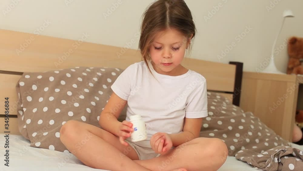 Little girl is sick at home. Children in a respiratory mask sits in quarantine at home. Baby is sick. Little girl is sick at home. Children in a respiratory mask sits in quarantine at home. Baby is sick.