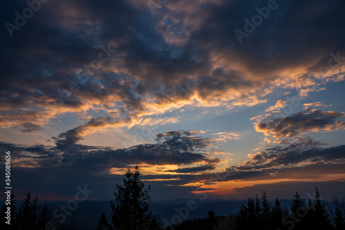 sunrise in the mountains with forest in the foreground with beautiful sky, czech republic beskydy Javorovy vrch