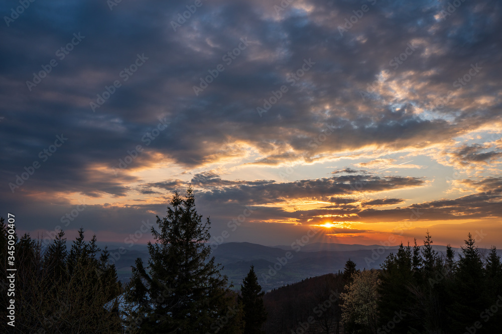 sunrise in the mountains with forest in the foreground with beautiful sky, czech republic beskydy Javorovy vrch