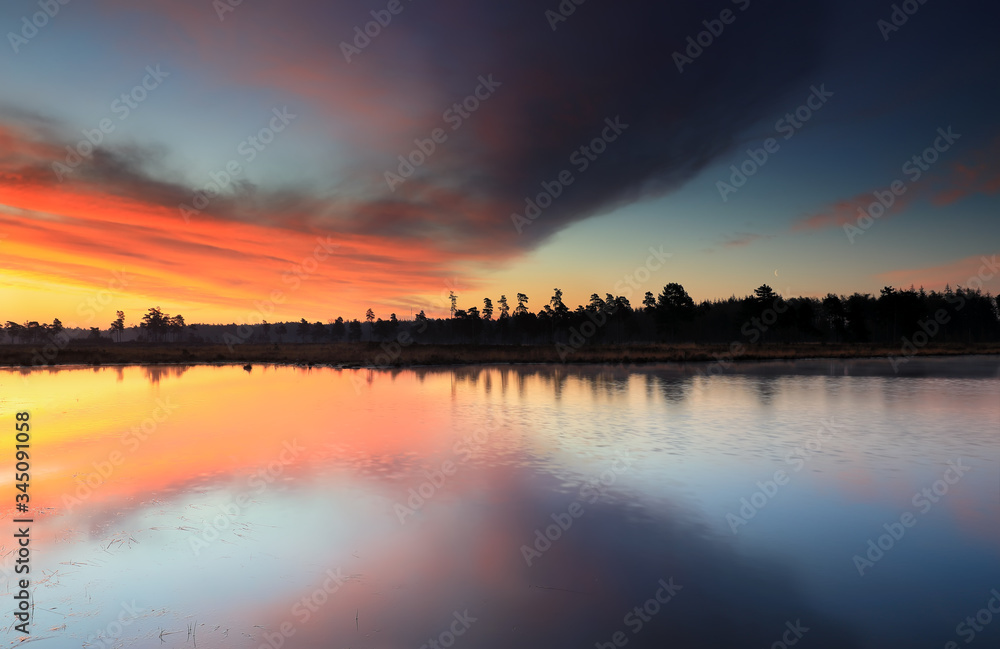dramatic sunrise over bif forest lake