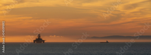 Φωτογραφία sunset over the moray firth including an oil rig and rig support vessel