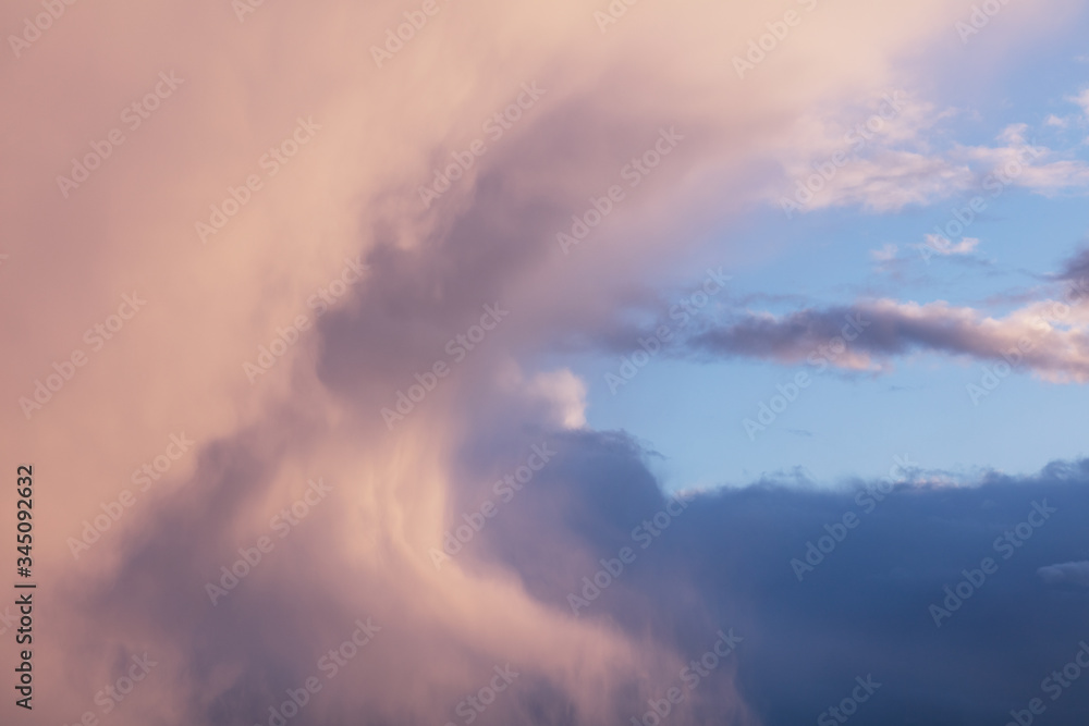 Huge pink dramatic clouds on the blue sky. Huge pink dramatic clouds on the blue sky.