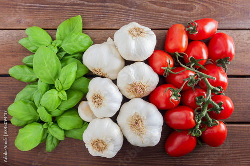 Italian flag from Italian food ingredients: basil, garlic, tomato.