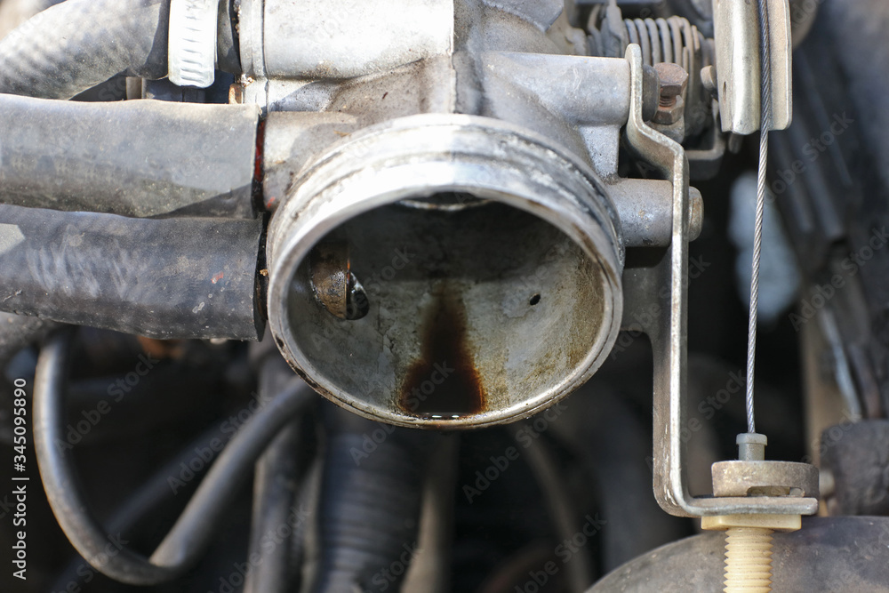 Motor oil on a car throttle.  Car engine is damaged. Selective focus.