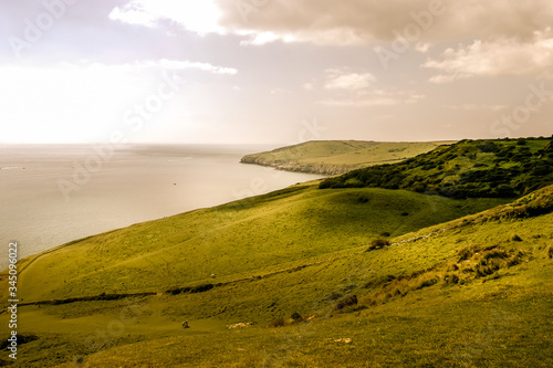 Looking West along the Jurassic Coast and its dramatic landscape on a late summer afternoon near Seacombe Cliff, Swanage, Dorset, England, UK