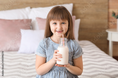 Little girl with bottle of ...
