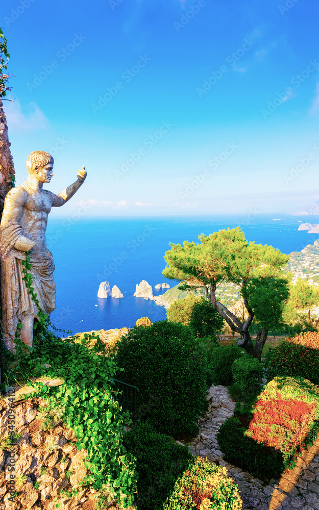 Statue and green gardens in Capri Island town reflex