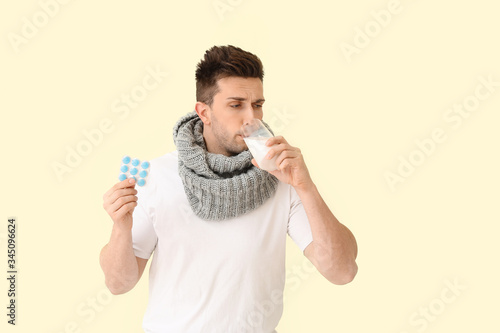 Young man ill with flu hold...