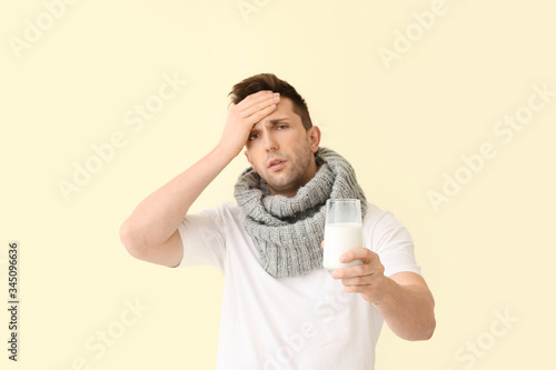 Young man ill with flu hold...