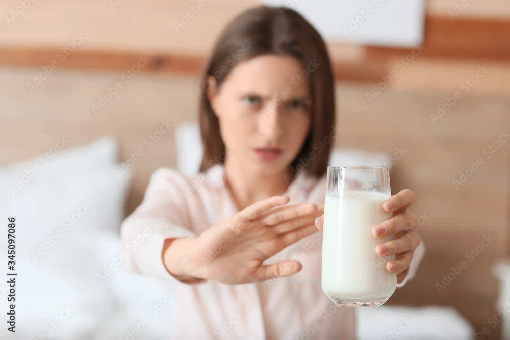 Young woman with milk allergy in bedroom Young woman with milk allergy in bedroom