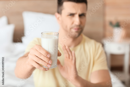 Young man with milk allergy in bedroom