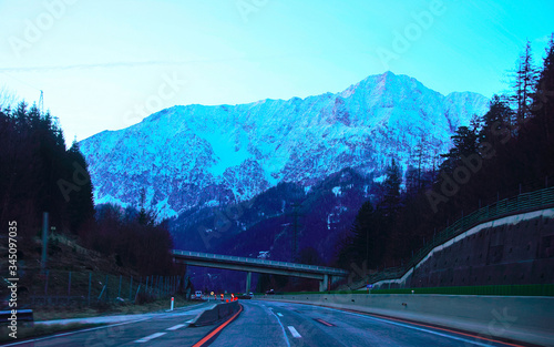 Road with twilight view on Alpine mountains in Austria reflex