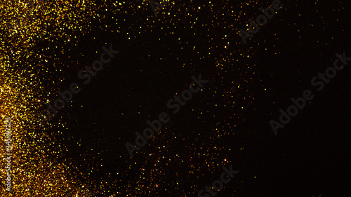 Abstract holiday background, gold Stardust on black.