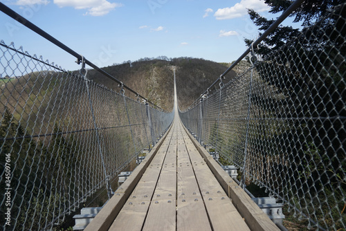 Fototapeta Naklejka Na Ścianę i Meble -   Suspension bridge. Pedestrian suspension bridge. COVID-19.