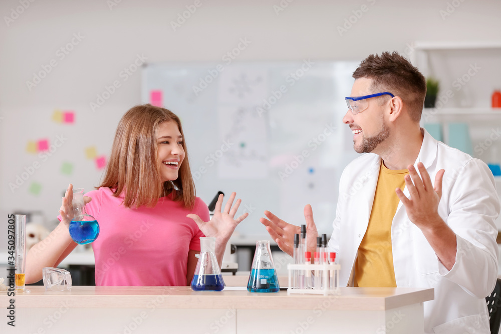 Teacher and pupil at chemistry lesson in classroom Teacher and pupil at chemistry lesson in classroom