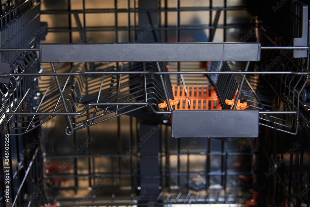 Open an empty dishwasher. Appliances in the kitchen Open an empty dishwasher. Appliances in the kitchen